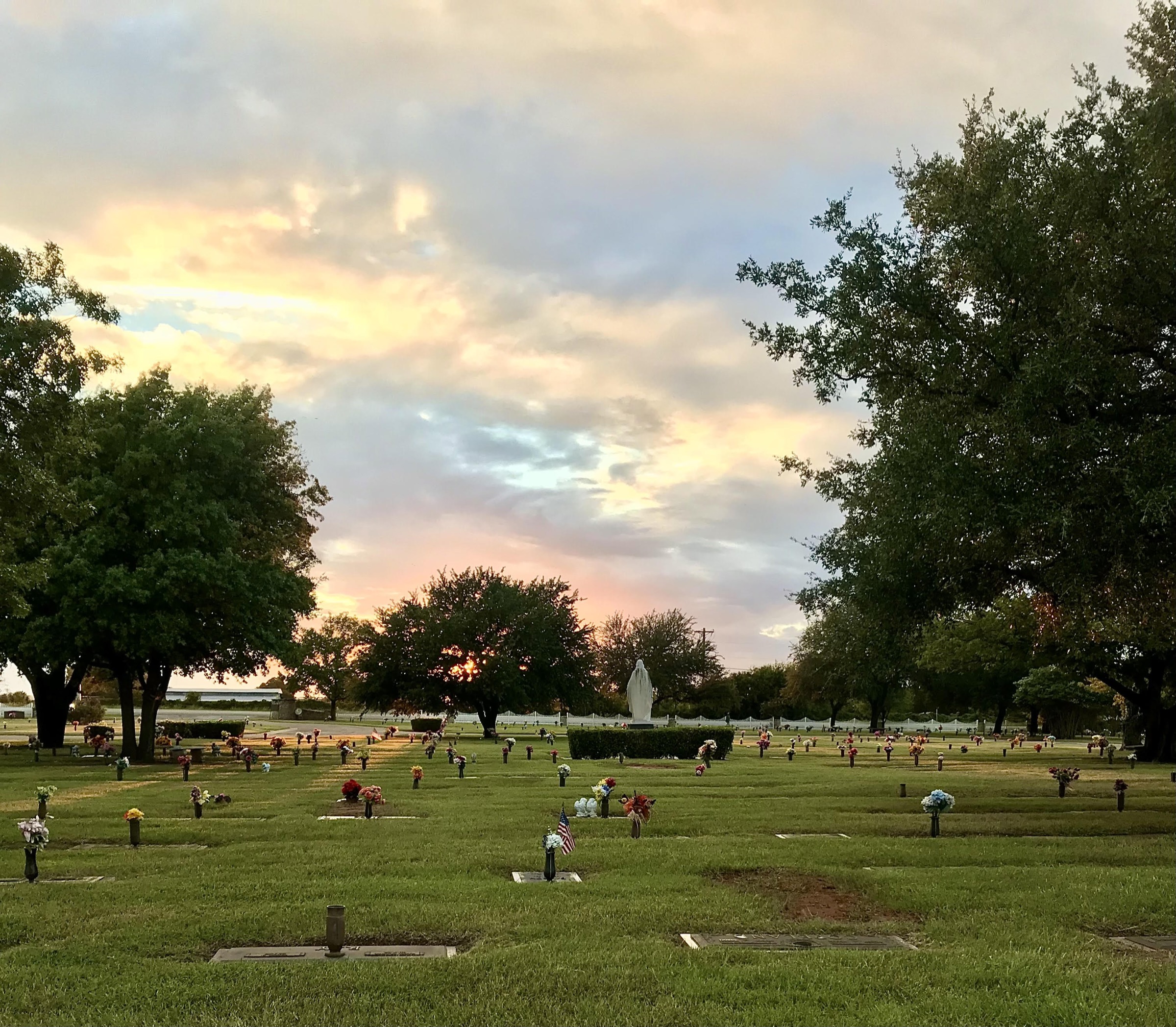 Evening clouds and warm light above the memorial park grounds