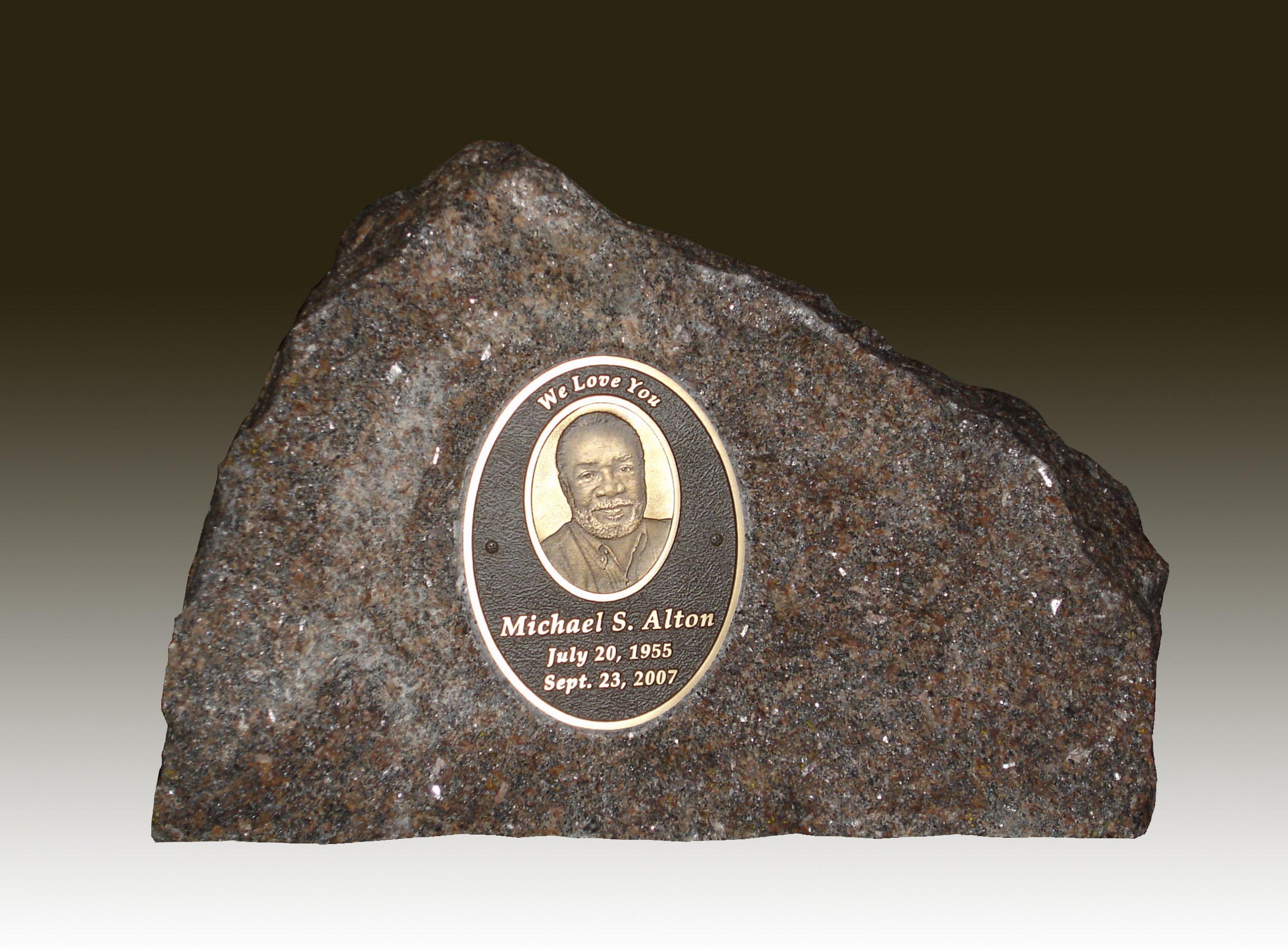 Natural stone memorial with a personalized portrait medallion